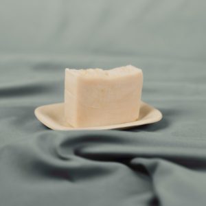 Handmade natural soap bar on a ceramic dish