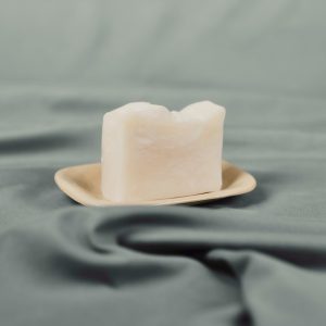 Handmade natural soap bar on a ceramic dish